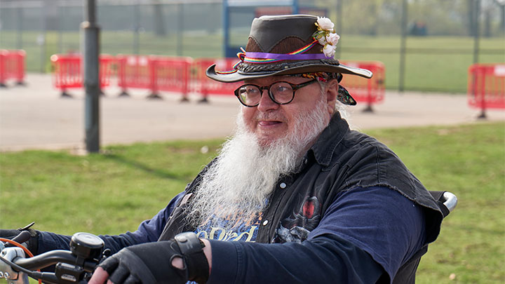 Man sat in mobility scooter in park Man sat in mobility scooter in park