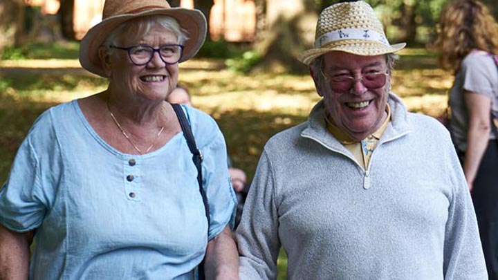 An older couple enjoying a walk together in a park.